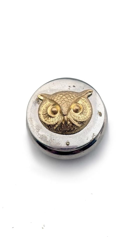 Silver round compact with gold owl face