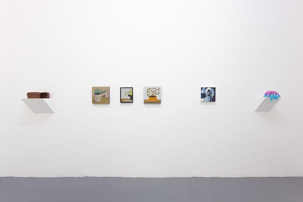 white gallery wall with small assorted artwokrs