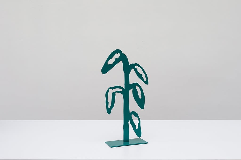 Metal sculpture of a green plant with 5 leafs