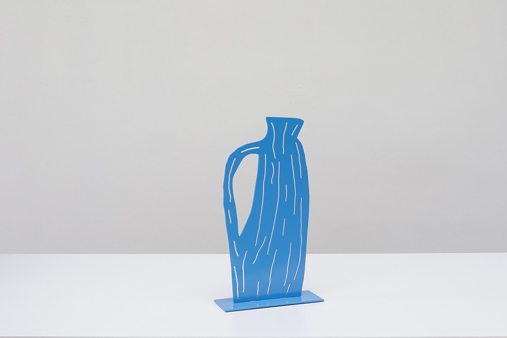 Metal sculpture of a blue jug with a handle