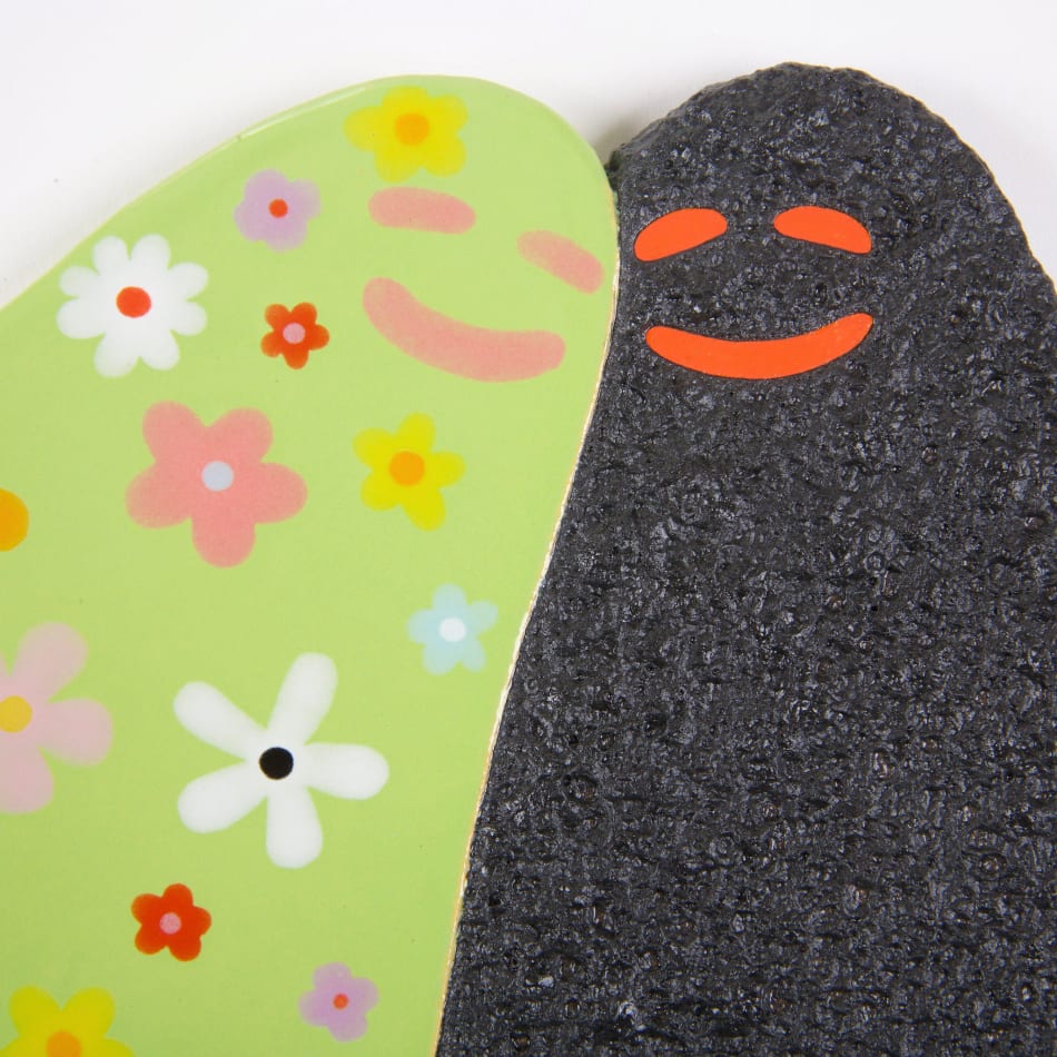 Lorien Stern's ceramic sculpture of two ghosts one black and one green with flowers