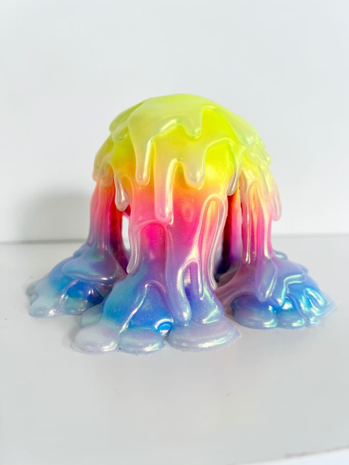 Dripping sculpture with a rainbow gradient and a waxy shiny coating by Dan Lam