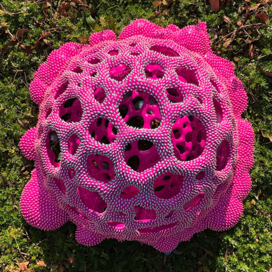 Sculpture by Dan Lam of a drippy sphere covered in tiny spikes with small holes in broken out of it