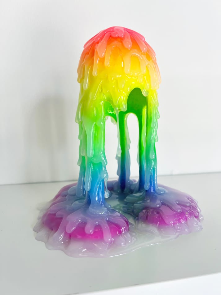 Tall dripping sculpture with a clear waxy coating by Dan Lam