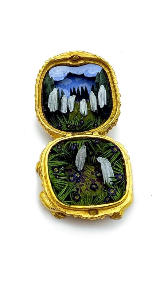 hand-cut watercolor collage in antique cosmetic compact by Shannon Taylor with several hovering ghost over green landscape