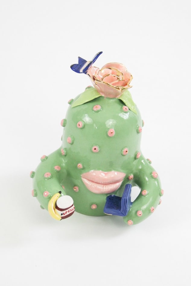 Jen Dwyer sculpture of green cactus with pink lips holding laptop, banana and Nutella jar
