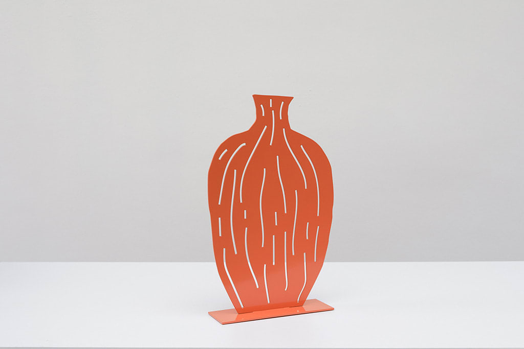 Metal sculpture of an orange vase