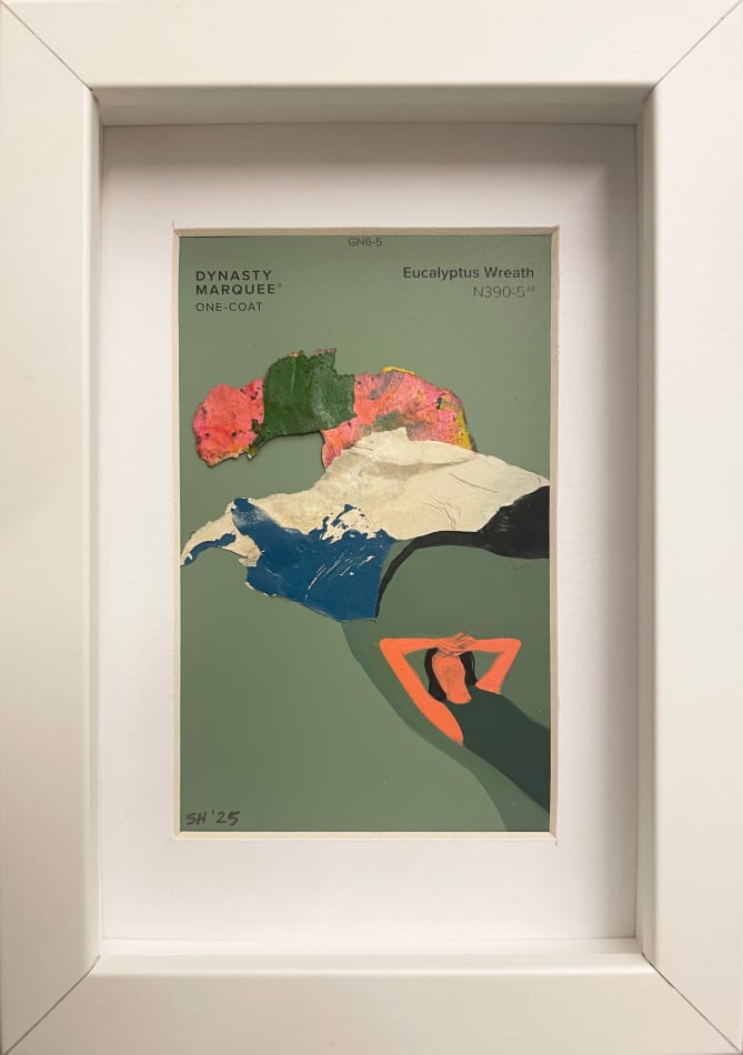 Painting on a green paint chip of a woman laying down in white frame