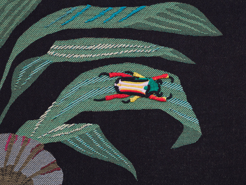 Detail of Oona Brangam-Snell hand-woven embroidery of large frog, flowers and fairy like women