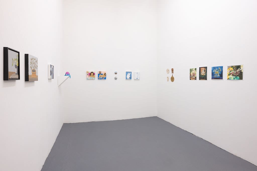 white gallery walls with assorted small artworks