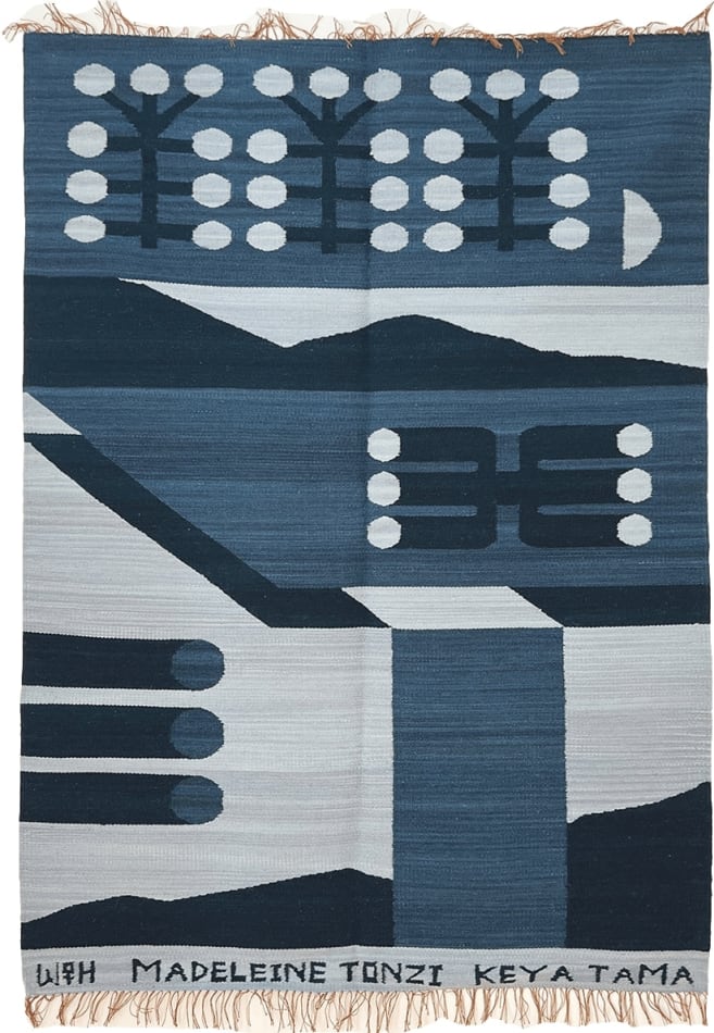 blue knit rug decorated with abstract shapes and symbols