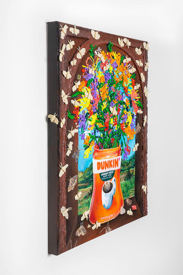 Nic Dyer's painting of colorful flowers displayed in a Dunkin Doughnuts can