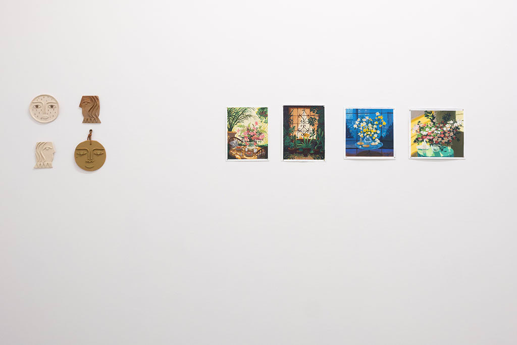 white gallery wall with small assorted artworks