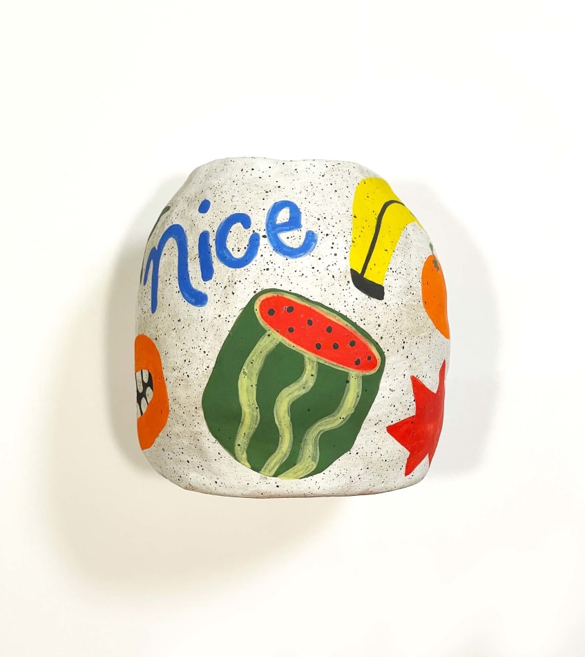 Jackie Brown's sculpture with of a vase with fruit on it
