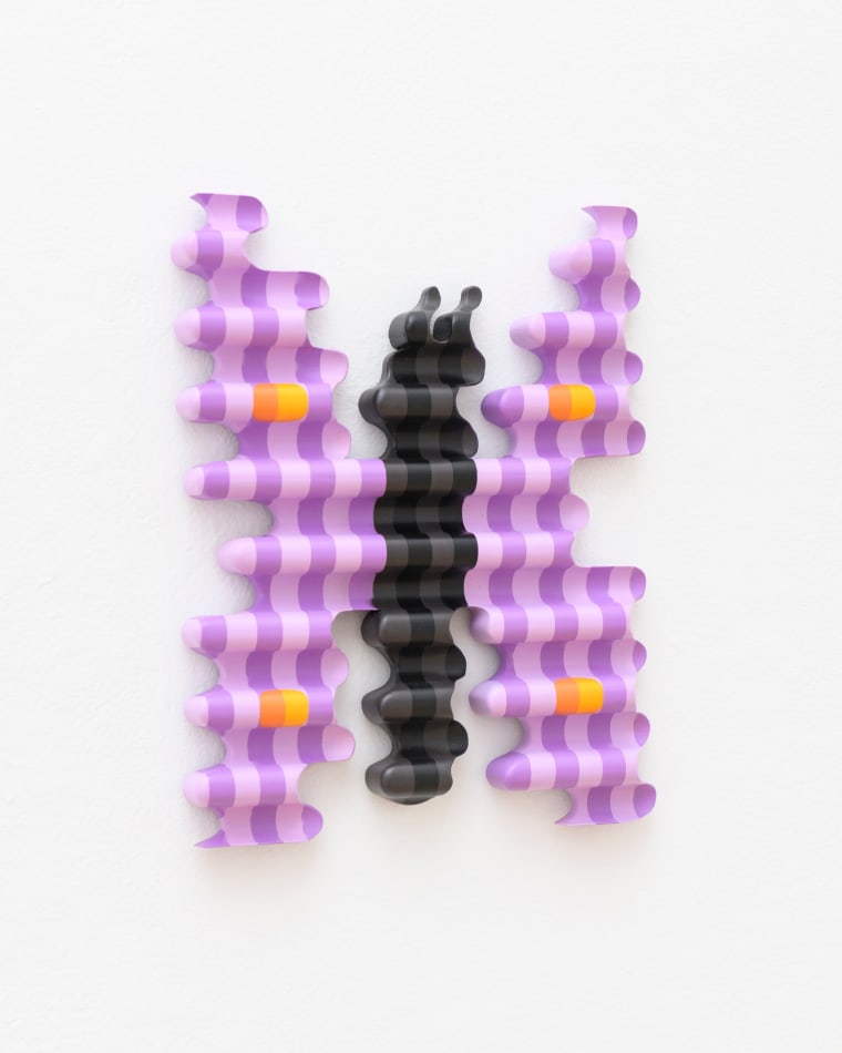 wooden sculpture of a purple by butterfly hanging on a wall by casey gray
