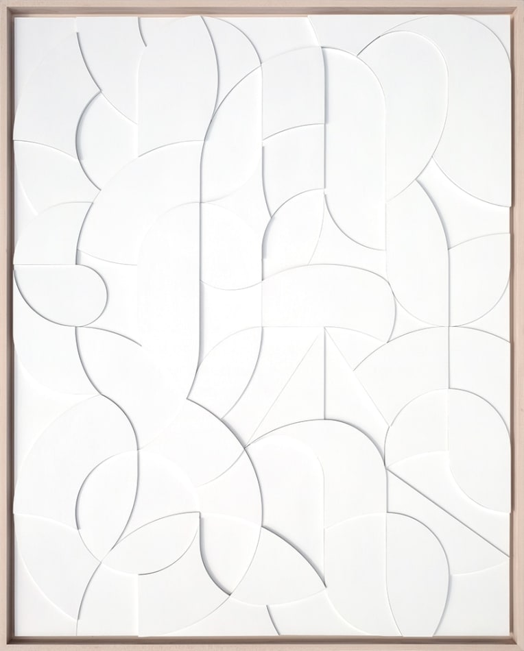 all white wooden relief piece made of many small pieces in a light wood frame