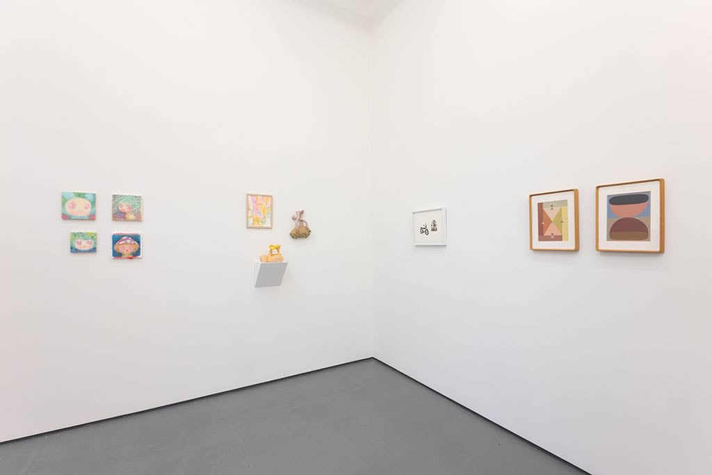 white gallery wall with small assorted artworks