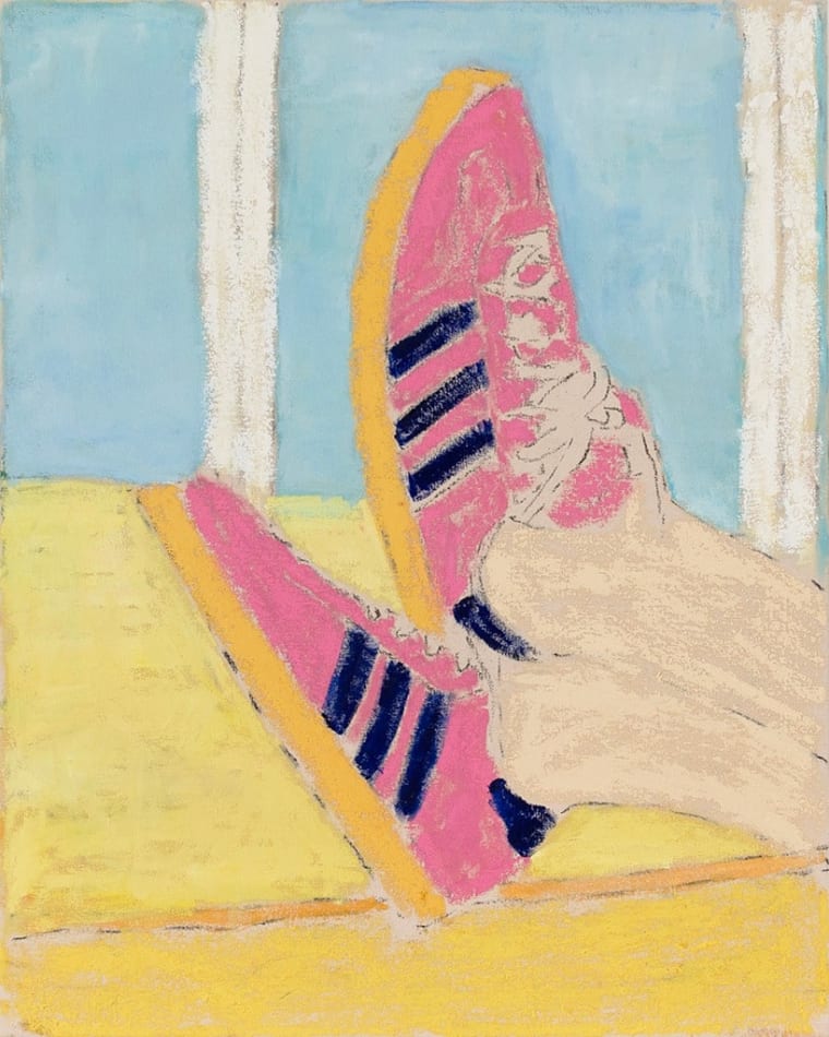 propped up feet wearing pink adidas sneakers