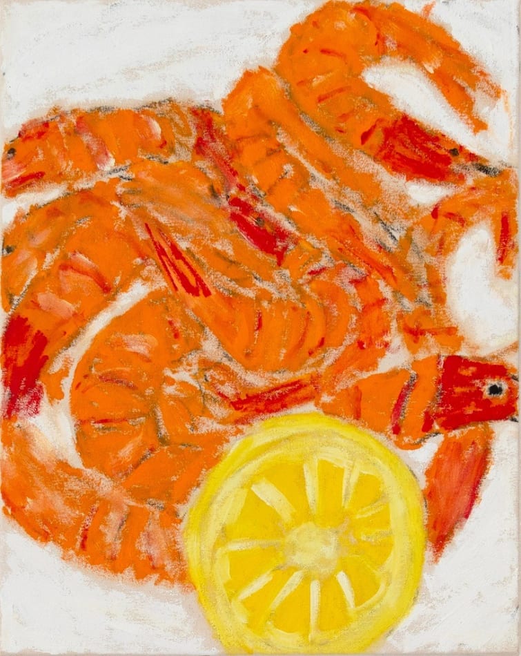 pile of shrimp and a lemon cut in half