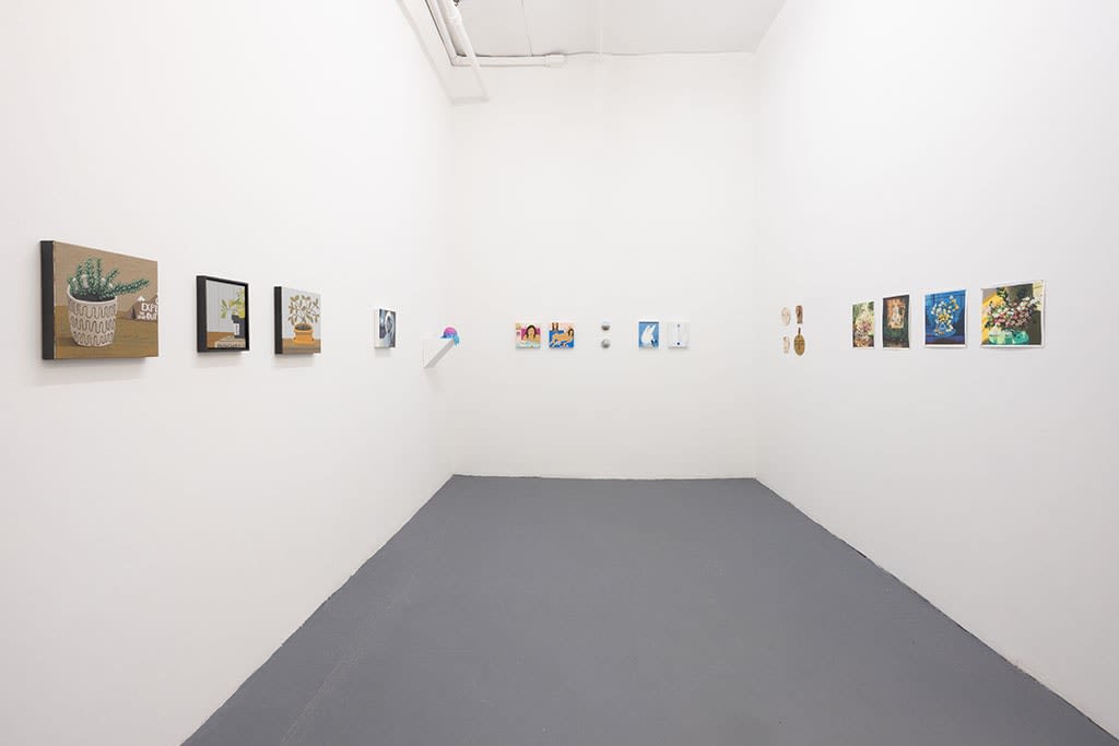 white gallery walls with small artworks