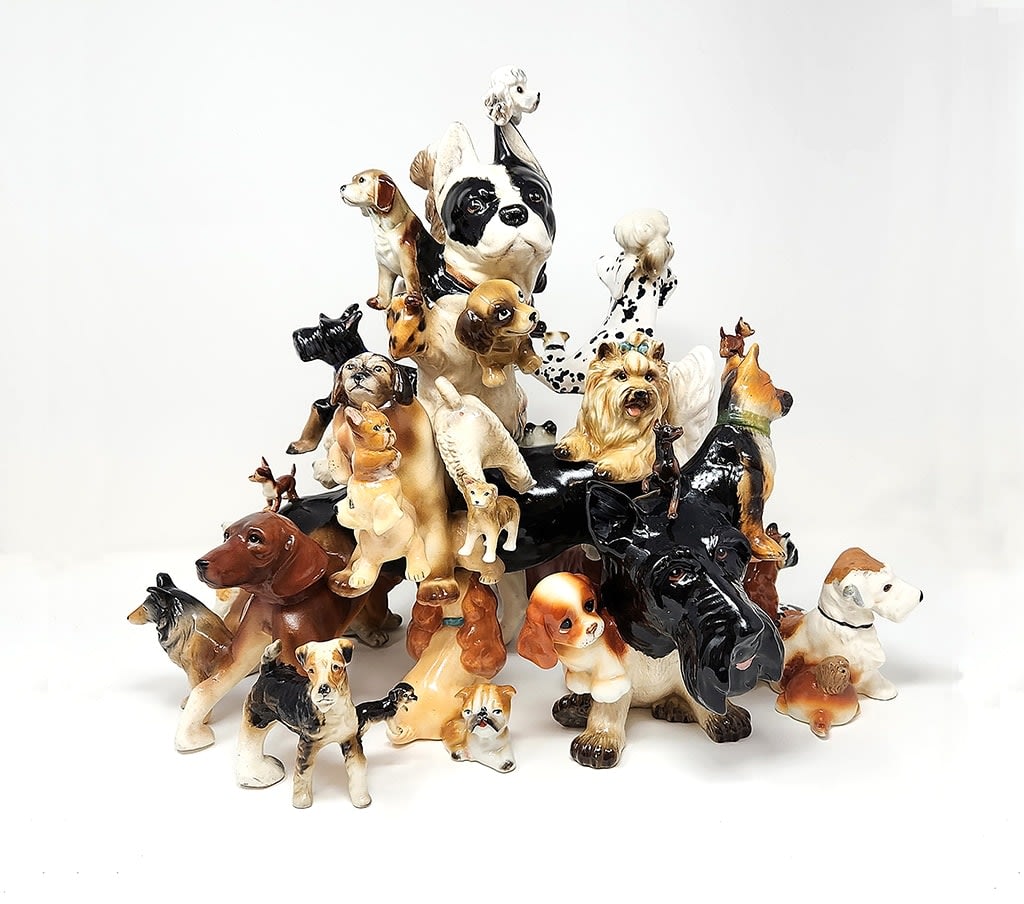 Debra Broz - ceramic and mixed media sculpture, dogs in all kinds of breed stacking together, shape like a small mountain