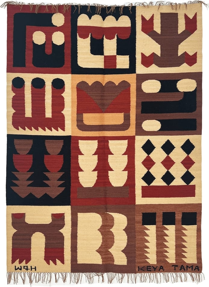 red, tan and black knit rug decorated with abstract symbols