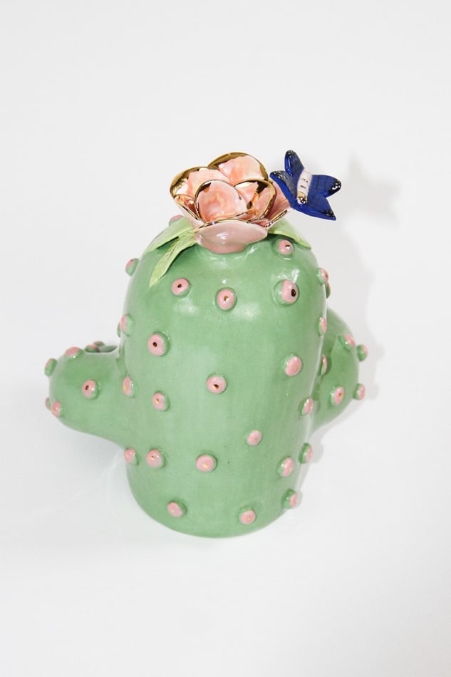 back of Jen Dwyer sculpture of green cactus with pink lips holding laptop, banana and Nutella jar