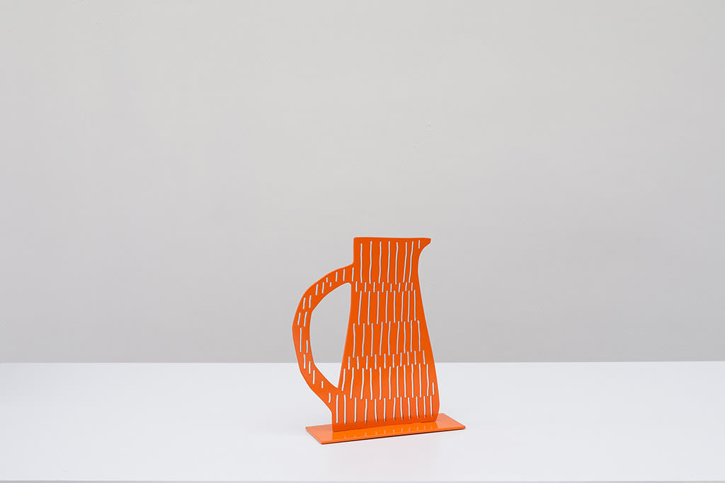 Metal sculpture of an orange jug with a handle