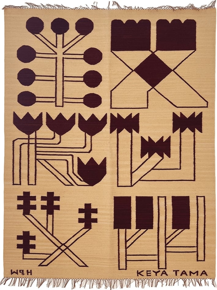 tan knit blanket displaying abstract symbols by the art Keya Tama
