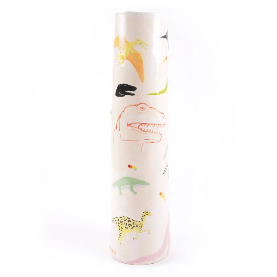off white ceramic base decorated with images of prehistoric creatures
