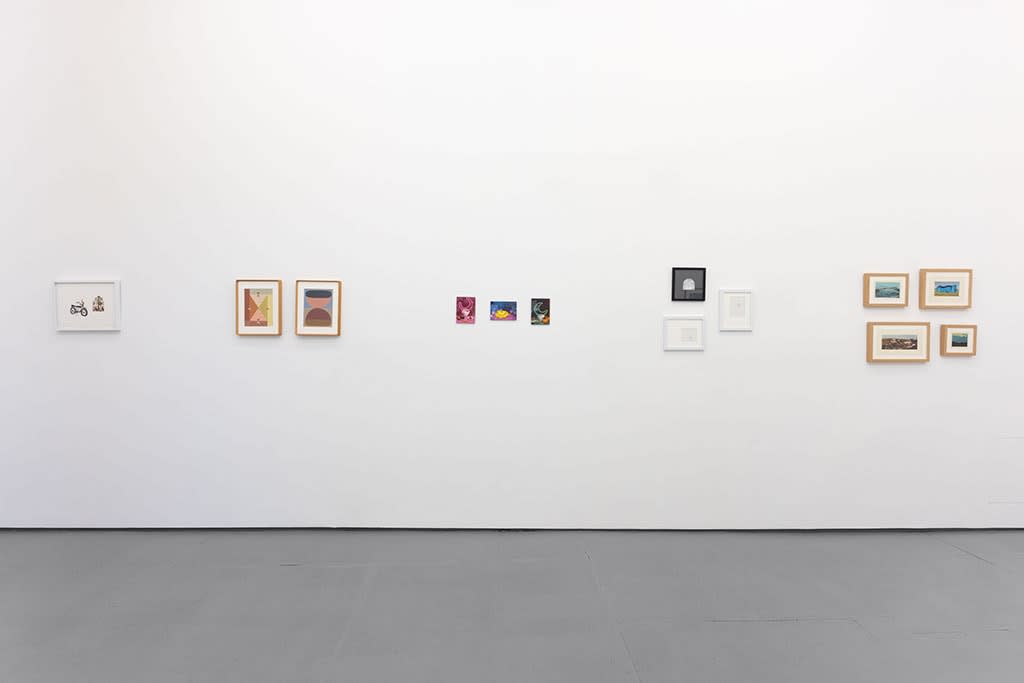 gallery wall with assorted small artworks