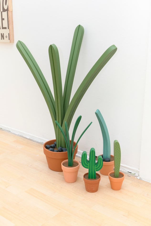 Jeff Canham wooden plant sculpture in a terra cotta pot - in a cluster on the floor