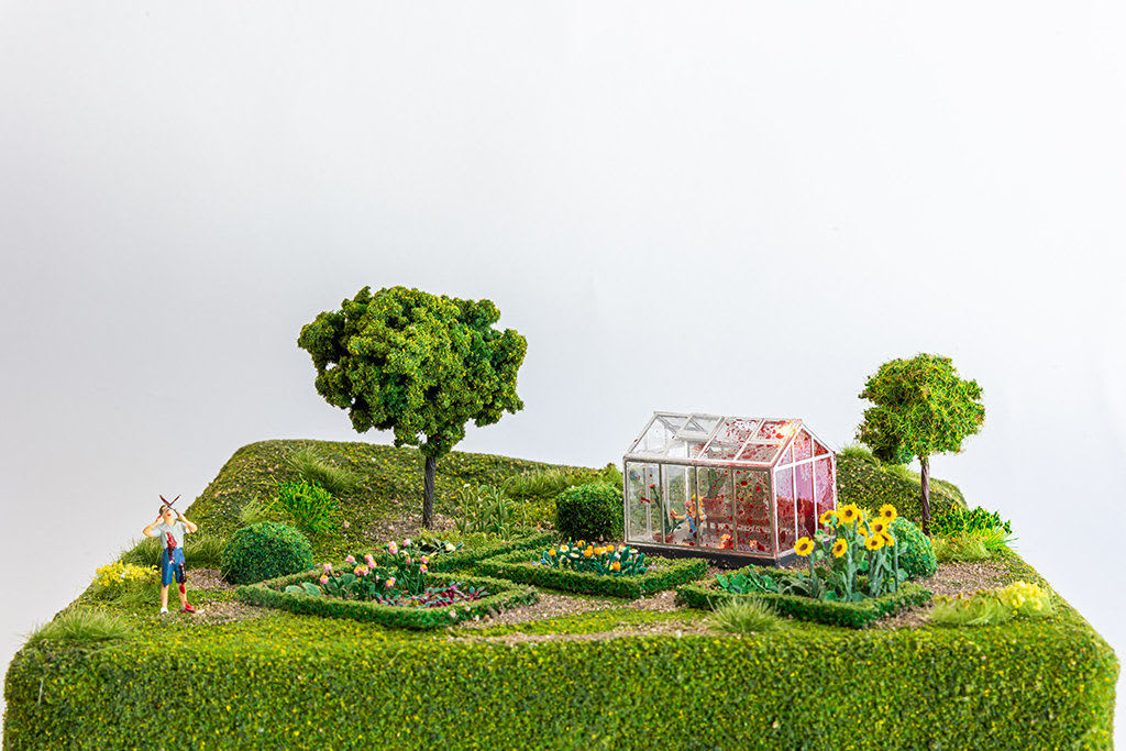 miniature diorama by Abigail Goldman of a person gardening and a dead body in their green house