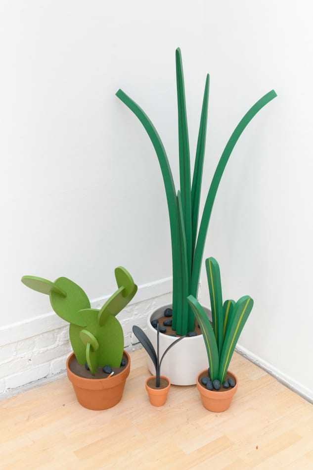 Jeff Canham wooden plant sculptures in terra cotta pots - in a cluster on the floor