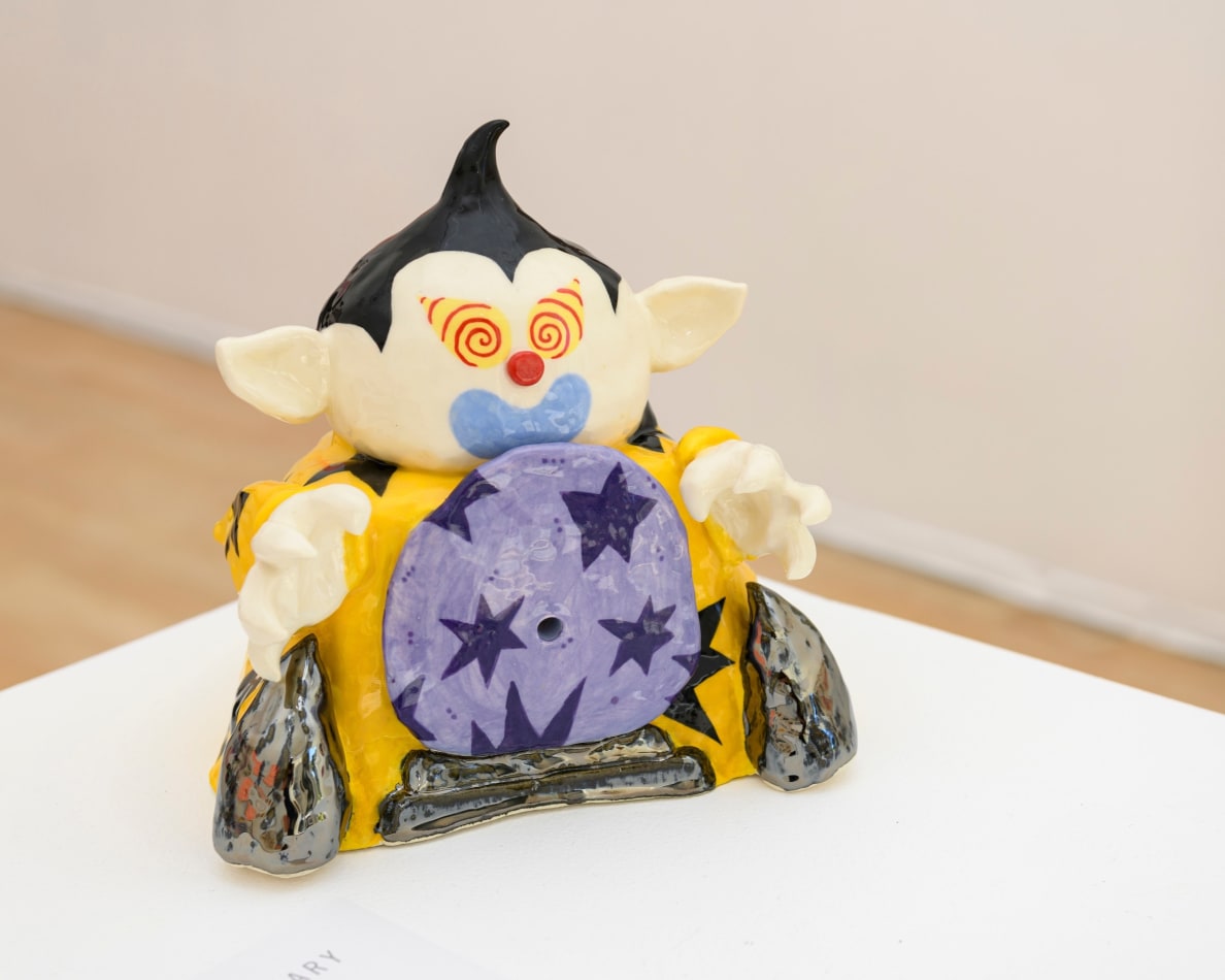 Christopher Gale's sculpture of goblin figure with a yellow jacket and black stars