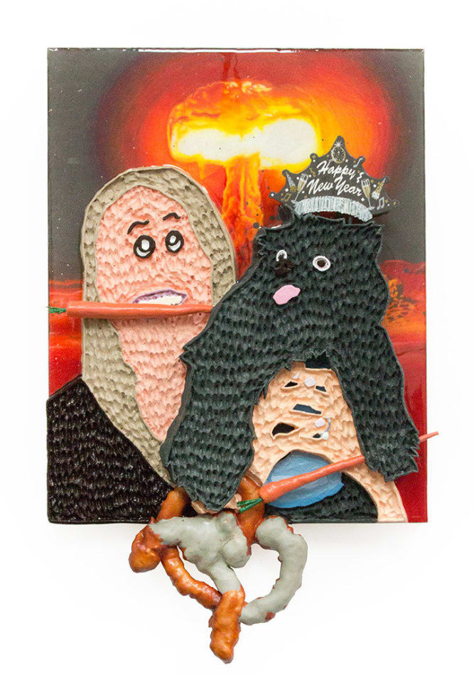 Mixed media hanging sculpture of a woman with a carrot in her mouth holding a small black dog with a Happy New Year paper crown on his head and a pretzel and a carrot in his hands. In the background an atomic bomb is going off.