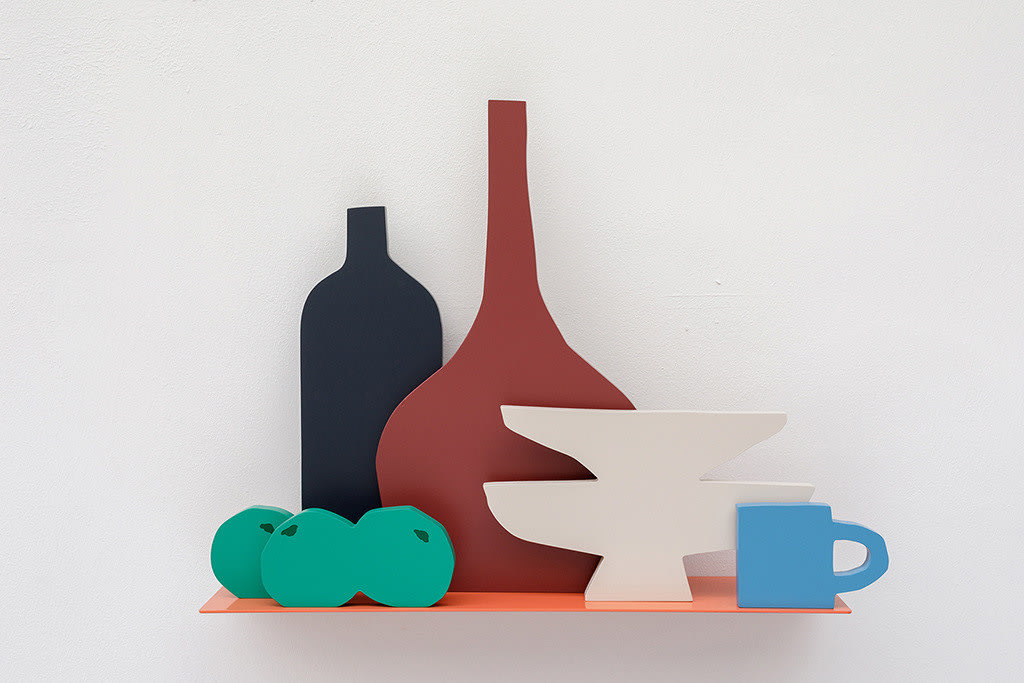 Sculpture of an orange shelf holding a pile of three limes, a black vase, a brown vase, two white plates stacked on top of each other and a blue mug.