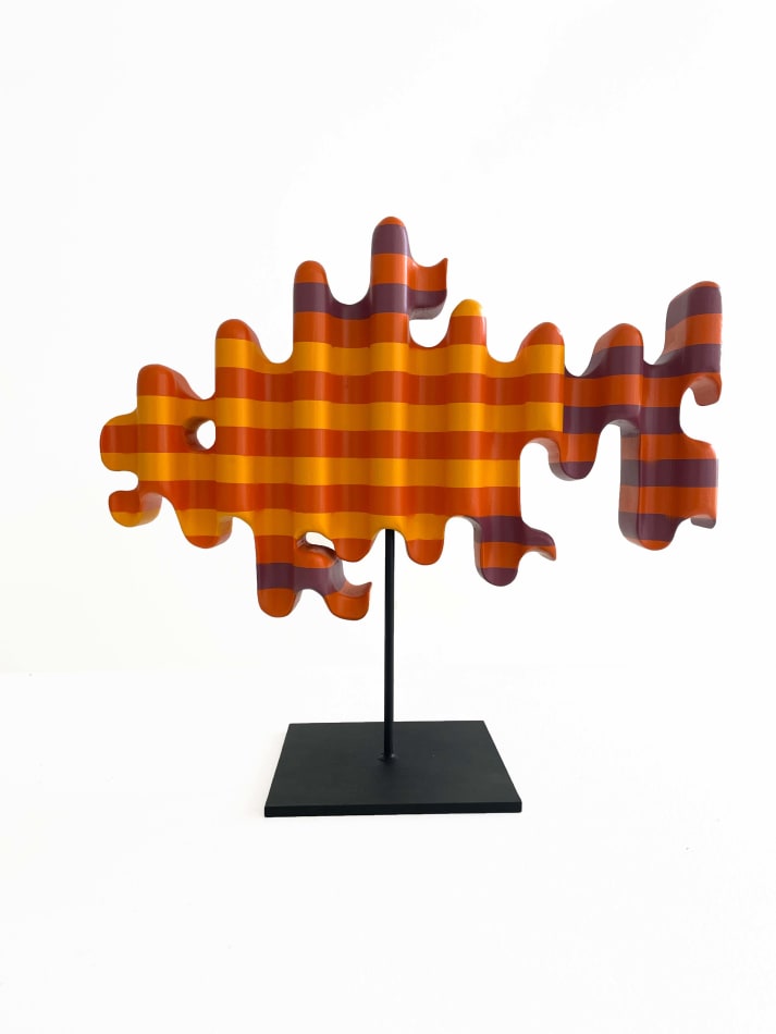 photo of a wooden sculpture in the shape of a goldfish by Casey Gray