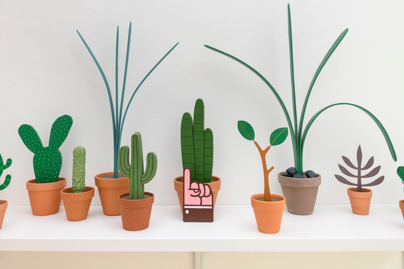 Jeff Canham wooden plant sculptures in terra cotta pots - in a cluster on a shelf