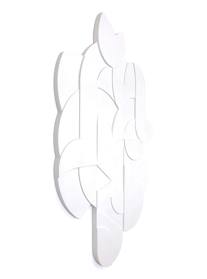 all white wooden relief piece featuring many smaller pieces side angle