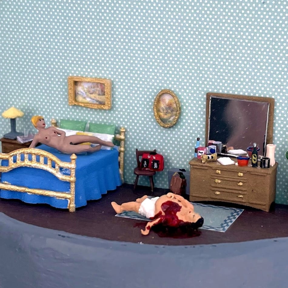 naked woman laying on bed while a man is bleeding from the chest on the floor