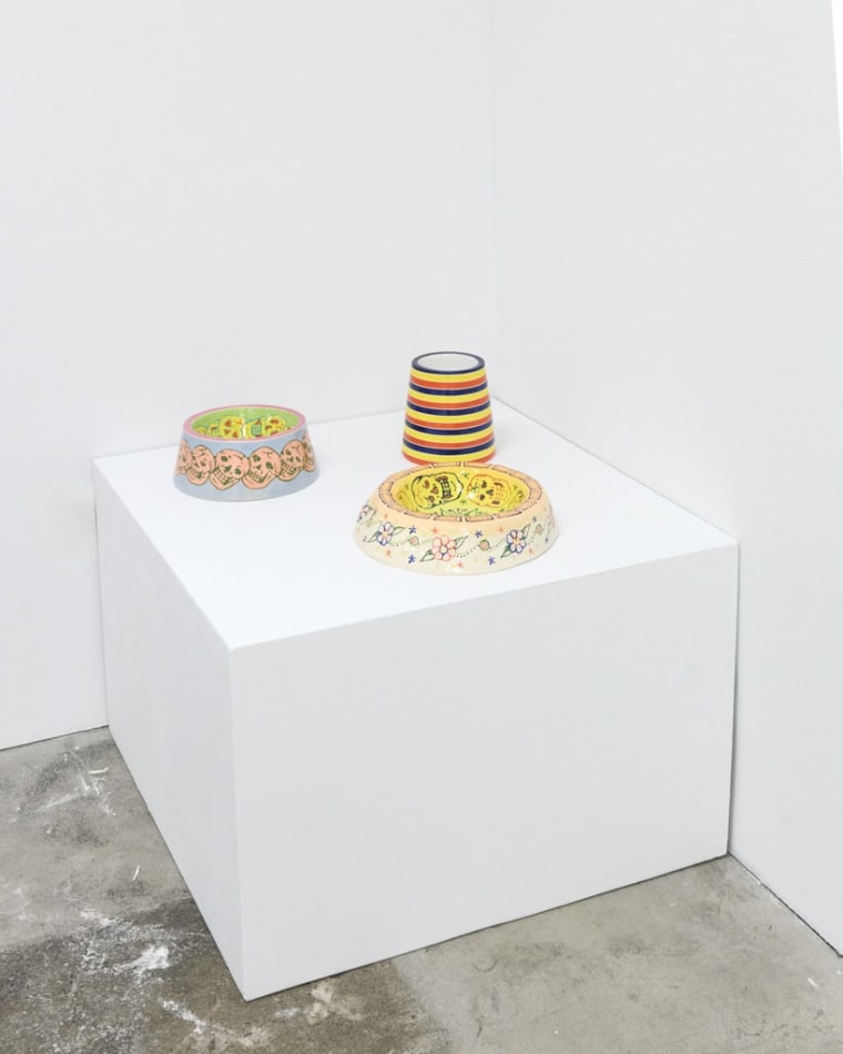 installation view of artist AP Shrewsbury's ceramic dog bowls on a pedestal, installed at Hashimoto Contemporary San Francisco