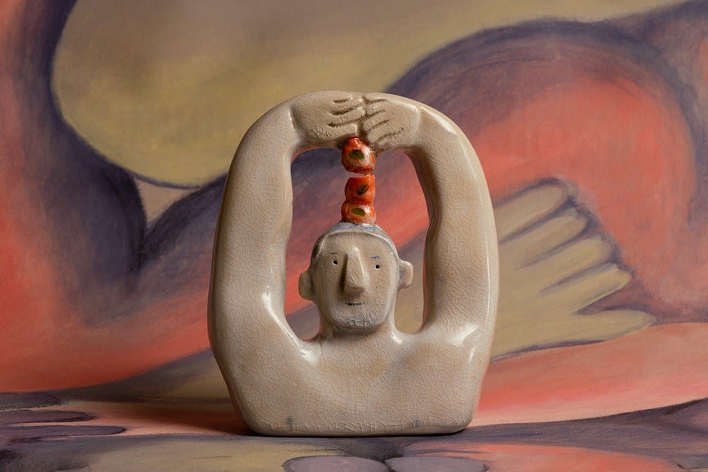 Sculpture of a man with apples on his head