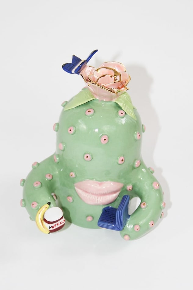 Jen Dwyer sculpture of green cactus with pink lips holding laptop, banana and Nutella jar