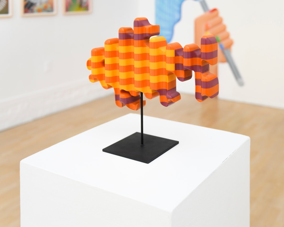 photo of a wooden sculpture in the shape of a goldfish by Casey Gray