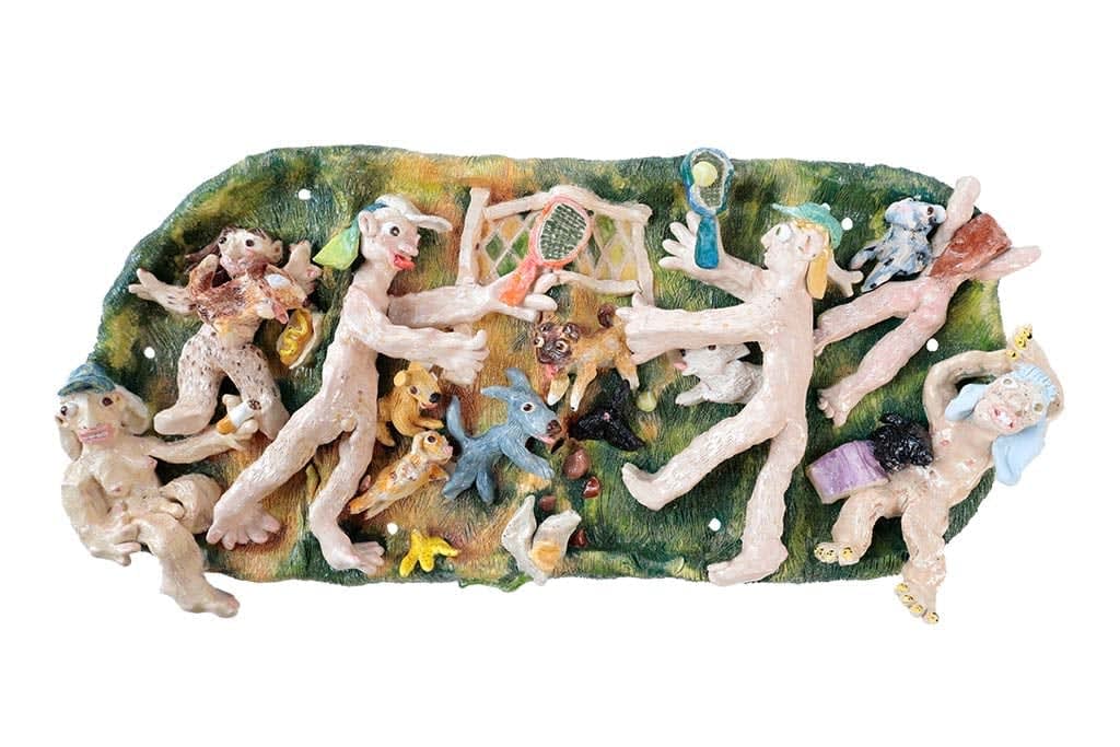 Ceramic sculpture of a bunch of naked people playing tennis with several dogs chasing the ball in the center