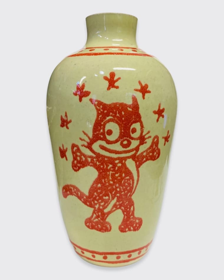 Adam Shrewsbury's vase of a cat like figure and a flower in red