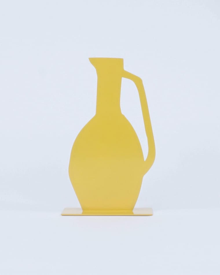 sculpture of a yellow vases with a long neck