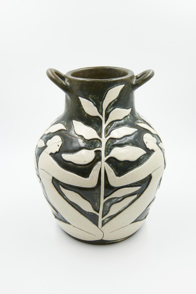 Hilda Palafox black vase sculpture with white women holding white leaves