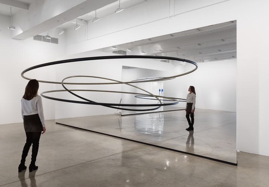 Image of Eliasson, mirrored panels reflecting circular sculptures